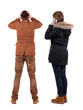 © ghoststone - Back view of couple in winter jacket photographed on a mobile phone in winter jacket.