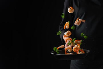 Professional chef prepares shrimps with greens. Cooking seafood, healthy vegetarian food, and food on a dark background. Horizontal view.