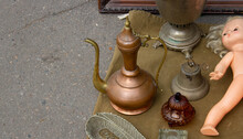 A Flea Market With A Large Assortment Of Antiques, Copper Jugs And Trinkets For Sale.