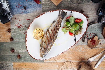 Grilled trout fish with salad and lemon