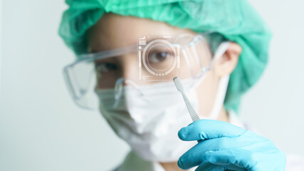 Women doctor holding a microscope glass slide in the laboratory.