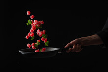 Frying Tuna In A Pan With Herbs, Oriental Cuisine, Asian Food, Cooking And Gastronomy, On A Black Background