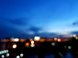 Blurred bokeh city night lights and space of blue sky as background