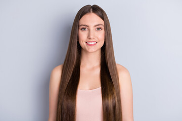 Wall Mural - Photo of attractive cute perfect appearance model lady beaming smile demonstrating ideal neat long healthy hairstyle after salon wear beige singlet isolated grey color background