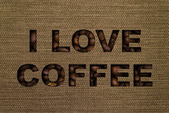 The text I love coffee made up of coffee beans on the background of a bag canvas fabric