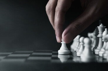 Man playing chess on dark background