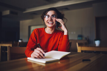 Wall Mural - charming funny female students in trendy eyewear having friendly phone conversation while making hom