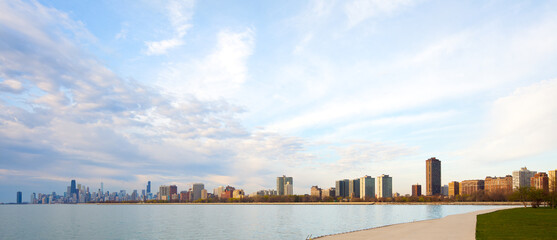 Wall Mural - Apartment buildings in the waterfront of Montrose Harbor and downtown city skyline of Chicago at dawn, Illinois, United States.