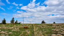Walking Path Marked With Poles Leading Towards The Horizon