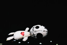 White Voodoo Doll With Red Heart Laying On Black Background. Witchcraft, Love Enchantment
