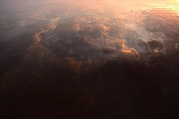Wall Mural - Reflection of the sky in the lake water at sunset