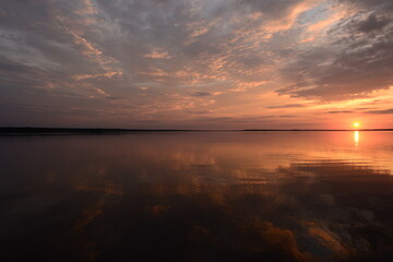 Wall Mural - Bright colors of the sky at sunset in the silence of a summer evening reflected on the lake water