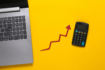 Wall Mural - Online business, trading. Laptop and Calculator with red growth arrow on yellow background. Arrow graph going up. The economic growth