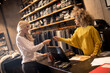 © BGStock72 - Woman paying female sales assistant with credit card in clothes shop