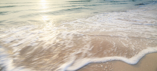 landscape sandy beach and the sea wave with the sunrise background