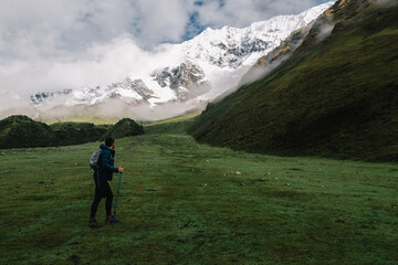 Wall Mural - Rear view of tourist enjoying amazing nature in mountains during hiking trek on holidays, Back view of traveller admiring beautiful landscape of Machu Picchu during wanderlust exploring environment