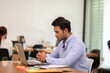 © 220 Selfmade studio - Portrait of Young business indian man working with laptop at office