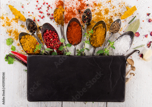 Various colorful spices on wooden table, top view. Canvas Print