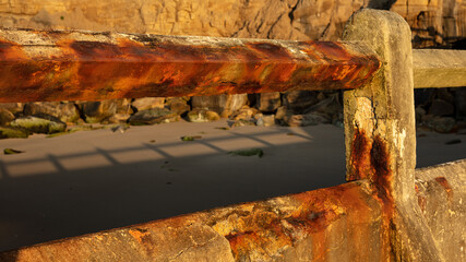 The ruined remains of an old tidal swimming pool at Tynemouth, Tyneside, in the north east of England, UK. Taken in evening sunlight.