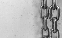 Large Chain Links On A Gray Background. The Concept Of Bondage And Restriction Of Freedom. Slavery. Free Space For Text.