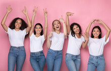 Five Girls Gesturing Different Symbols Posing Over Pink Studio Background