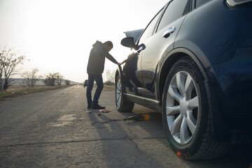 man and defective car in street