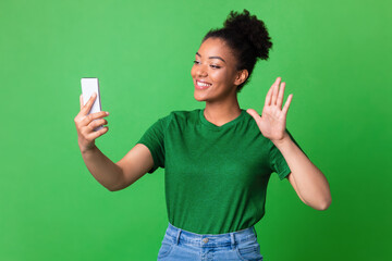 Wall Mural - Happy girl using mobile phone at studio