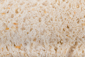 Slice of white Bread skin surface texture pattern close up detail macro. Abstract background.