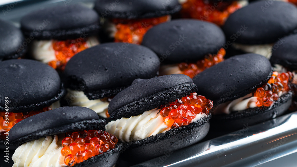 canape macaroons with cream cheese and red caviar