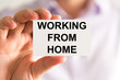 © stanciuc - Businessman holding Working From Home message card
