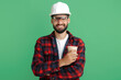 Bearded engineer or constructor man in plai shirt standing with paper cup of coffe or tea over green background.