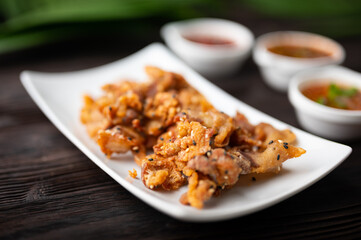 Wall Mural - Crispy fried sliced belly pork with spicy sauce