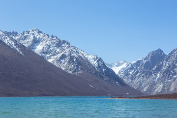 Nianbaoyuze, A sacred lake in Tibet with green water and snow mountains in the back.