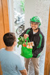 © Odua Images - portrait of happy male courier delivering online grocery shopping to customer at home