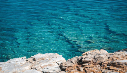 Wall Mural - Beautiful sea background, clear azure water and a reef bottom. Stone coast