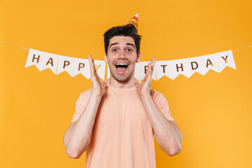 Canvas Print - Photo of excited young man in party cone expressing surprise on camera