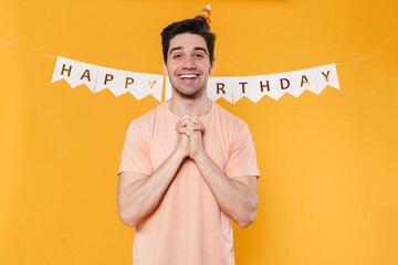 Canvas Print - Photo of happy man in party cone smiling and holding hands together