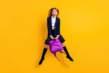 Wall Mural - Full length body size view of her she small little cheerful amazed funky girlish girl jumping having fun after class new collection clothes isolated bright vivid shine vibrant yellow color background