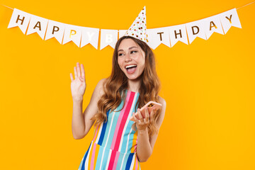 Poster - Image of joyful cute woman using mobile phone and waving hand