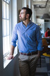 © Wavebreak Media - Caucasian man looking at the window in an office