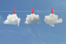 Clips For Laundry Hanging Clouds On A String Rope On Blue Sky