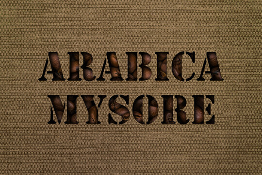 Variety Arabica Mysore text made up of coffee beans on a canvas background