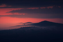Dark Landscape, Hills And Mountains In Mist At Twilight