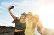 © Roman - friends on the beach one summer day taking a selfie. Background the sea and the clear sky