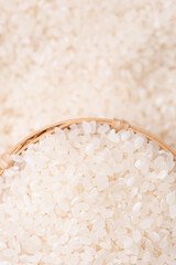 Wall Mural - Raw rice in a bowl and full frame in the white background table, top view overhead shot, close up