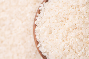 Wall Mural - Raw rice in a bowl and full frame in the white background table, top view overhead shot, close up