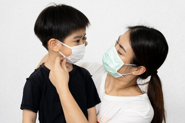 portrait woman and her son waring mask for protect corona virus on white background.	