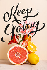 Wall Mural - floral and fruit composition with citrus fruits, strawberry and peach near keep going no matter what lettering on beige