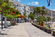 Few residents resting or walking on the usually very busy promenade in front of Playa Los Cristianos on Av. Juan Alfonso Batista in Los Cristianos, Arona, Tenerife, Canary Islands, Spain