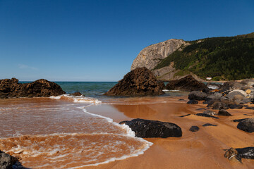 Wall Mural - Summer Mediterranean sea-coast landscape.Cliffs and rocks on the Atlantic ocean coast in Cantabria on a beautiful summer day,Spain.Beautiful sea water